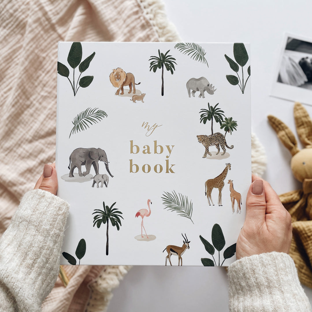 A collection of beautiful memory books, to help record every moment of your new born babies life. Image features the Blush and Gold baby book in safari.