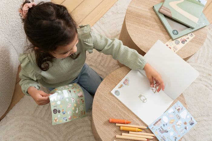 Girl playing with Little Dutch Farm Stickers