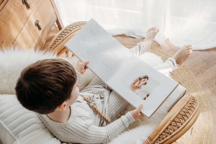Young child reading a baby memory journal