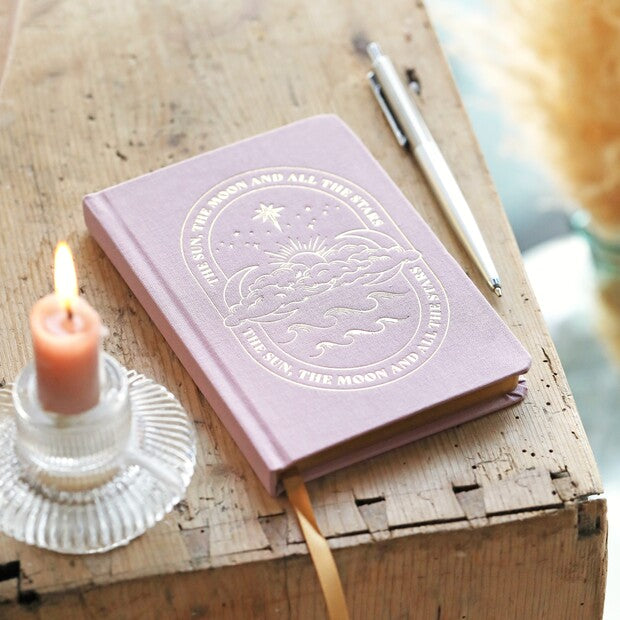Lisa Angel design products that inspire and bring a little joy. The image features their sun and moon journal.