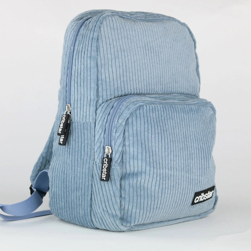 Cribstar is a London based independent clothing and accessories brand with a mission to create simple yet stylish apparel. Image features the blue corduroy backpack.