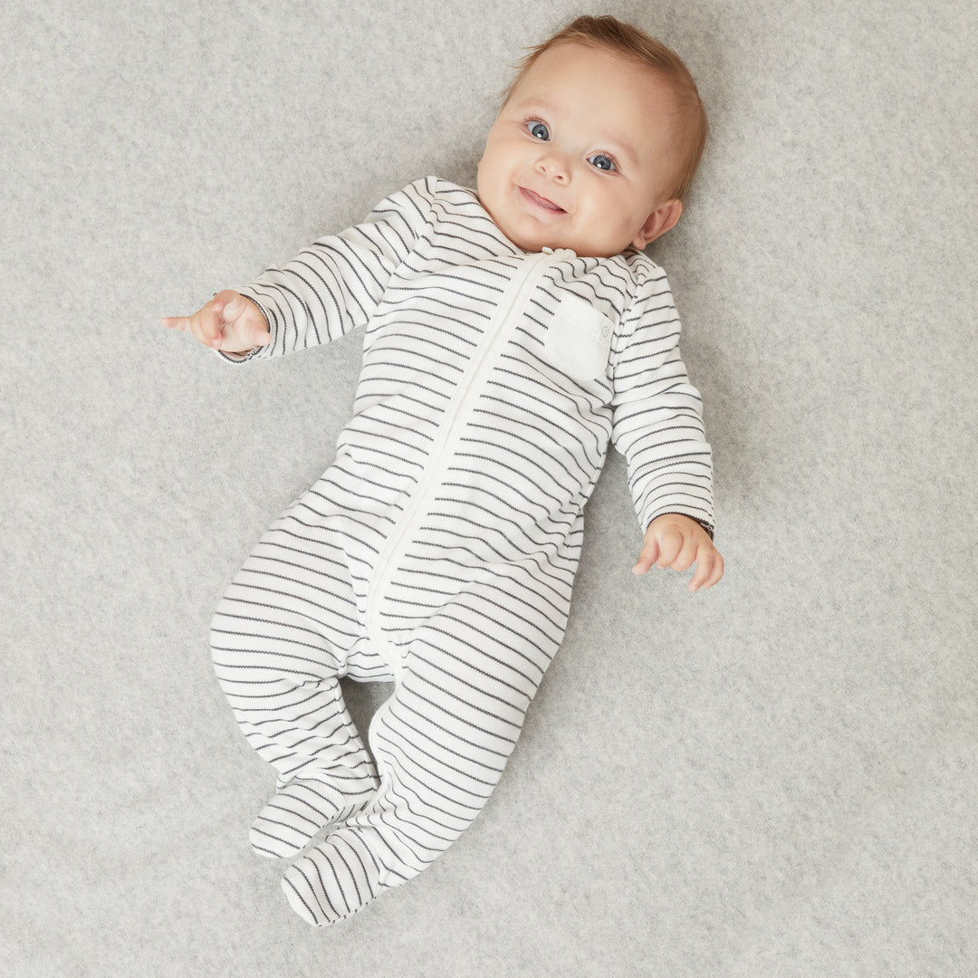 Baby Mori creates sleepwear unique blend of bamboo and organic cotton. Image features baby wearing grey stripe clever zip sleepsuit