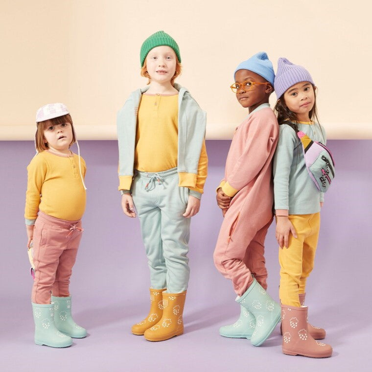 Grass & Air create stylish kids outerwear, designed to withstand any adventure regardless of the weather. Image features the Grass & Air colour changing wellies.