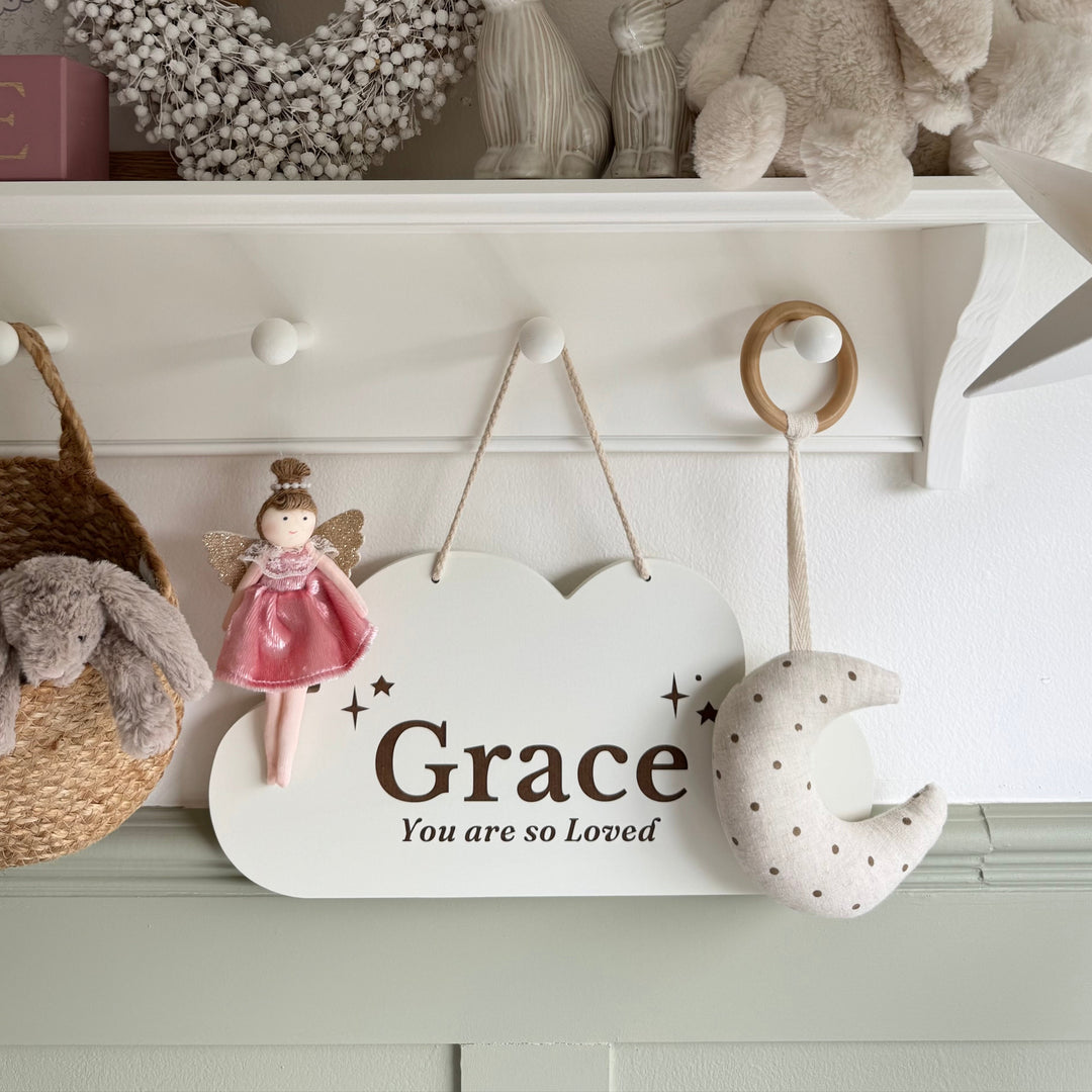 Decorative shelf with toys and a sign reading 'Grace You are so Loved' in a home setting.